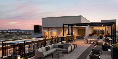 Hotel rooftop with lounge area and pool at Hilton BNA Nashville Airport Terminal.

