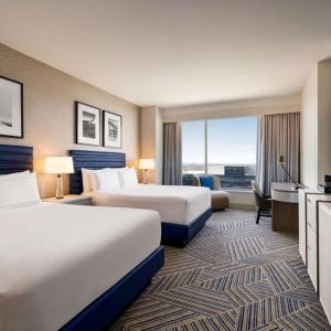 Day use room with two beds and workdesk at Hilton BNA Nashville Airport Terminal.
