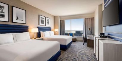 Day use room with two beds and workdesk at Hilton BNA Nashville Airport Terminal.
