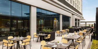 Hotel terrace with seating at Hilton BNA Nashville Airport Terminal.
