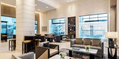 Hotel lobby with comfortable seating at Hilton BNA Nashville Airport Terminal.

