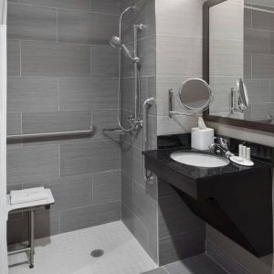 Ptivate guest bathroom with shower at Fairfield Inn & Suites By Marriott New York Staten Island.