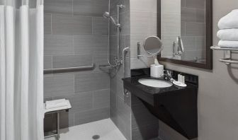 Ptivate guest bathroom with shower at Fairfield Inn & Suites By Marriott New York Staten Island.