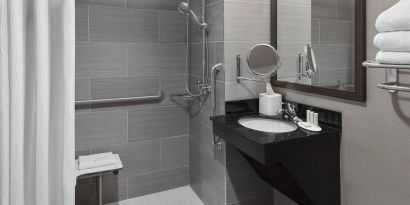Ptivate guest bathroom with shower at Fairfield Inn & Suites By Marriott New York Staten Island.
