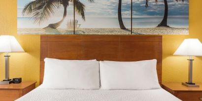 King bed at EnVision Hotel Miami International Airport.