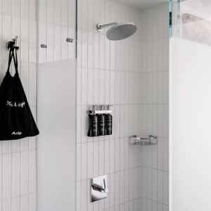 Private guest bathroom with shower and free toiletries at Arlo SoHo.