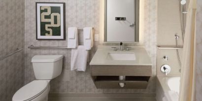 Guest bathroom with shower and tub at Hilton Birmingham At UAB.