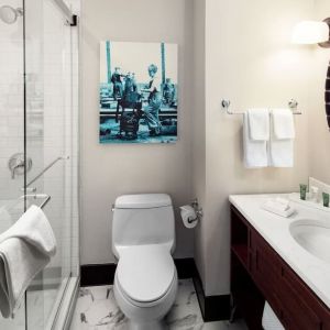 Private guest bathroom with shower and free toiletries at Hilton Brooklyn New York.