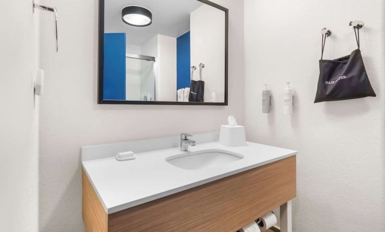 Private guest bathroom with shower and free toiletries at Spark By Hilton Pearland.