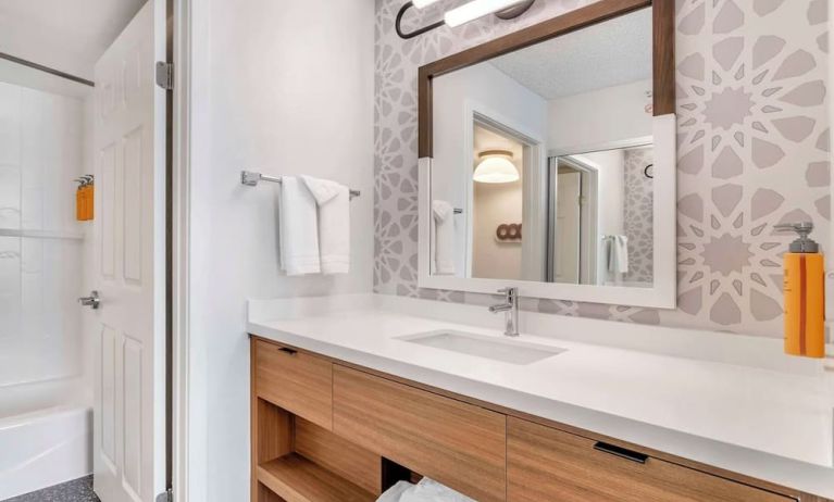 Private guest bathroom with shower and free toiletries at Sonesta ES Suites San Antonio Downtown Alamo Plaza.