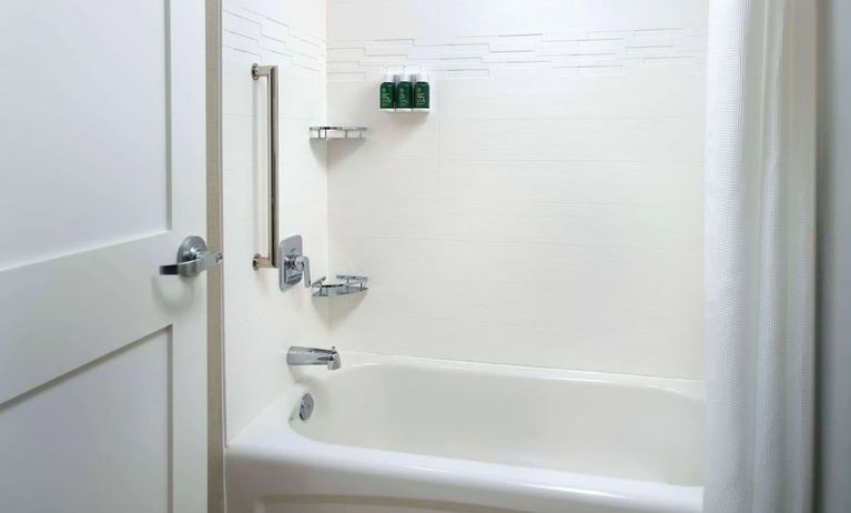 Private guest bathroom with tub and free toiletries at Sonesta ES Suites Raleigh Cary.