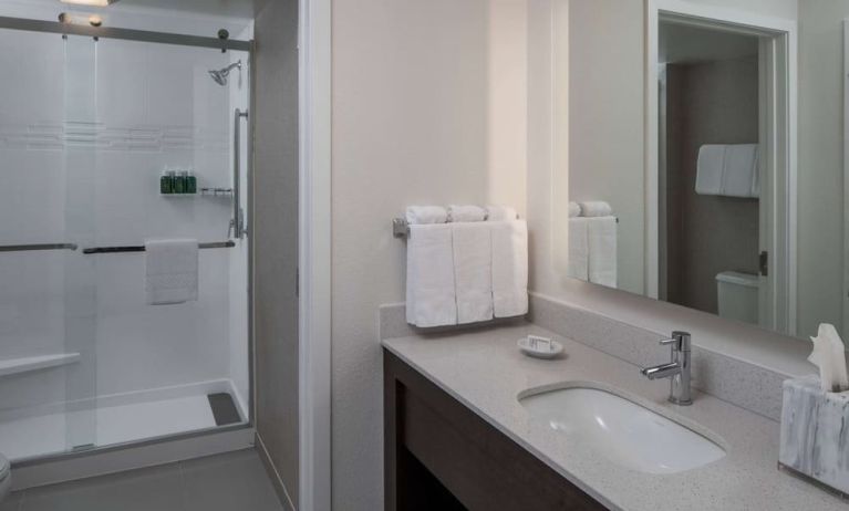 Private guest bathroom with shower and free toiletries at Sonesta ES Suites Fairfax Fair Lakes.