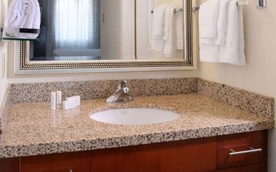 Private guest bathroom with shower and free toiletries at Sonesta ES Suites Dallas Medical Market Center.