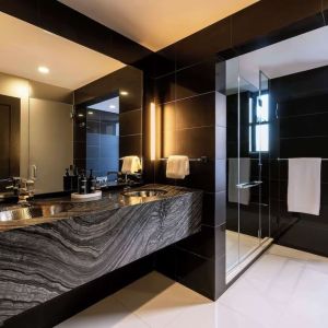 Private guest bathroom with shower and free toiletries at The Benjamin Royal Sonesta New York.