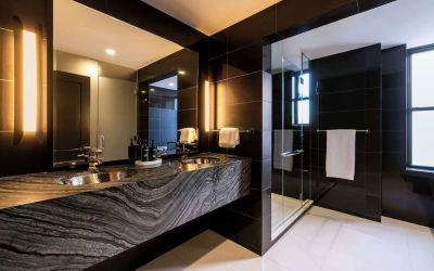 Private guest bathroom with shower and free toiletries at The Benjamin Royal Sonesta New York.