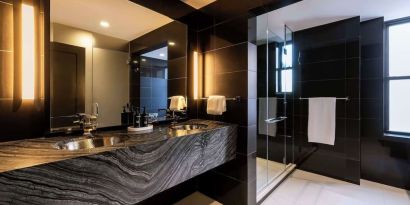 Private guest bathroom with shower and free toiletries at The Benjamin Royal Sonesta New York.