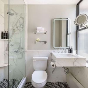 Private guest bathroom with shower at The Benjamin Royal Sonesta New York.