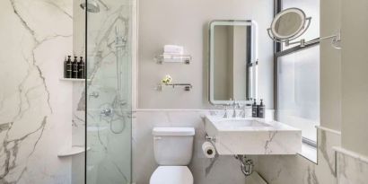 Private guest bathroom with shower at The Benjamin Royal Sonesta New York.
