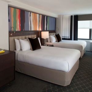 Day use twin room with lounge area at The Fifty Sonesta Select New York.