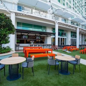 Alfresco dining and lounge area beside a bar at Hilton Orlando.