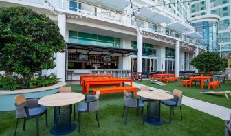 Alfresco dining and lounge area beside a bar at Hilton Orlando.