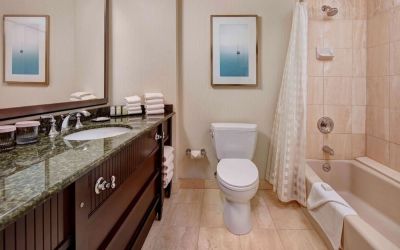 Guest bathroom with shower and tub at Embassy Suites By Hilton San Diego-La Jolla.