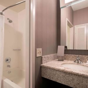 Private guest bathroom with shower and free toiletries at Sonesta Select Tempe Downtown.