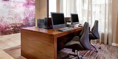 Business center with computers, printers and ergonomic chairs at Sonesta Select Raleigh Durham Airport Morrisville.