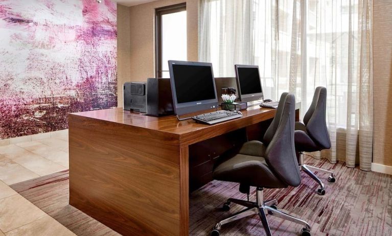 Business center with computers, printers and ergonomic chairs at Sonesta Select Raleigh Durham Airport Morrisville.