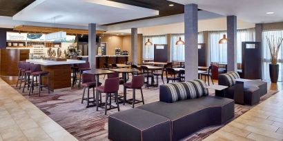 Dining area with comfortable seating perfect for coworking at Sonesta Select Raleigh Durham Airport Morrisville.