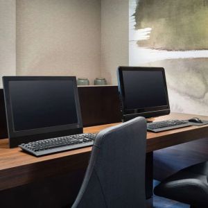 Business center with computers and ergonomic chairs at Sonesta Select Phoenix Camelback.