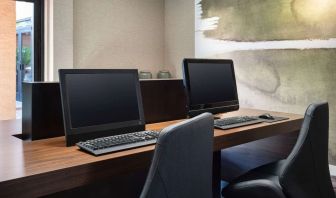 Business center with computers and ergonomic chairs at Sonesta Select Phoenix Camelback.