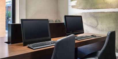 Business center with computers and ergonomic chairs at Sonesta Select Phoenix Camelback.