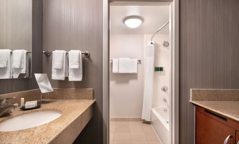 Private guest bathroom with combined shower and tub at Sonesta Select Phoenix Camelback.