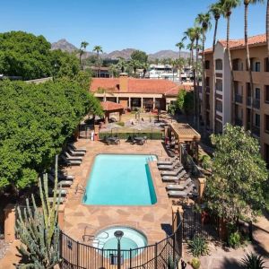 Outdoor pool with lounge seating at Sonesta Select Phoenix Camelback.