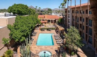 Outdoor pool with lounge seating at Sonesta Select Phoenix Camelback.