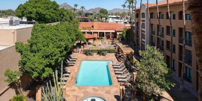 Outdoor pool with lounge seating at Sonesta Select Phoenix Camelback.