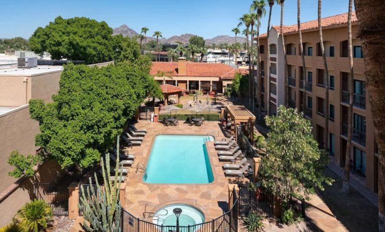 Outdoor pool with lounge seating at Sonesta Select Phoenix Camelback.