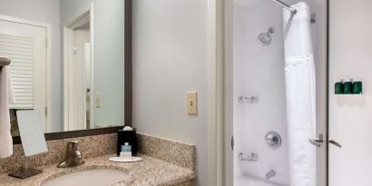 Private guest bathroom with shower and free toiletries at Sonesta Select Newport Middletown.