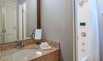 Private guest bathroom with combined shower and tub at Sonesta Select Kansas City Airport Tiffany Springs.