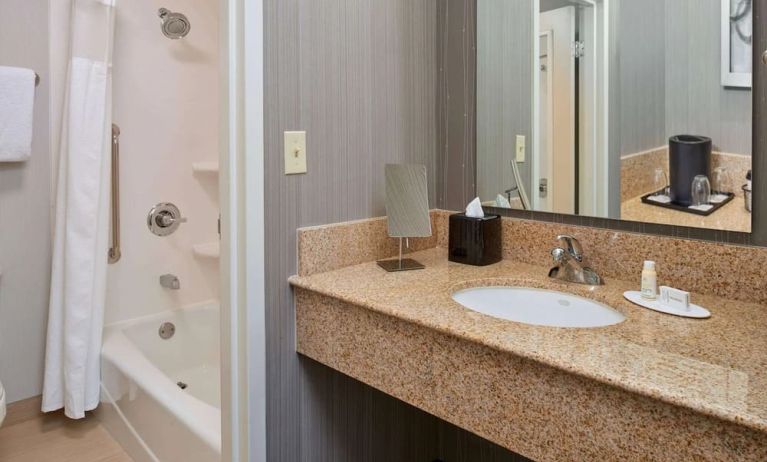 Private guest bathroom with shower and free toiletries at Sonesta Select Indianapolis Carmel.