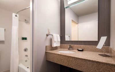 Private guest bathroom with shower and free toiletries at Sonesta Select Los Angeles LAX El Segundo.