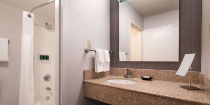 Private guest bathroom with shower and free toiletries at Sonesta Select Los Angeles LAX El Segundo.