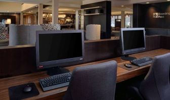 Business center with computers, printer and ergonomic chair at Sonesta Select Kansas City South Overland Park.