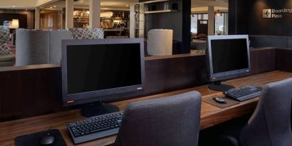 Business center with computers, printer and ergonomic chair at Sonesta Select Kansas City South Overland Park.