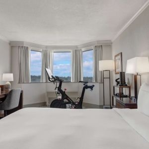 Day use room with work desk and Peloton bike at Hilton Crystal City At Washington Reagan National Airport.