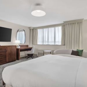 Day use room with work desk and sofa at Hilton Crystal City At Washington Reagan National Airport.