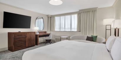 Day use room with work desk and sofa at Hilton Crystal City At Washington Reagan National Airport.