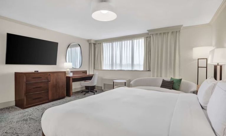 Day use room with work desk and sofa at Hilton Crystal City At Washington Reagan National Airport.