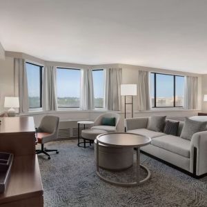 Beautiful king suite with work desk, TV, and sofa at Hilton Crystal City At Washington Reagan National Airport.